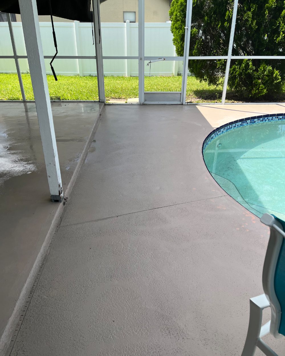 Freshly cleaned pool deck and screen enclosure at a Palm Bay home